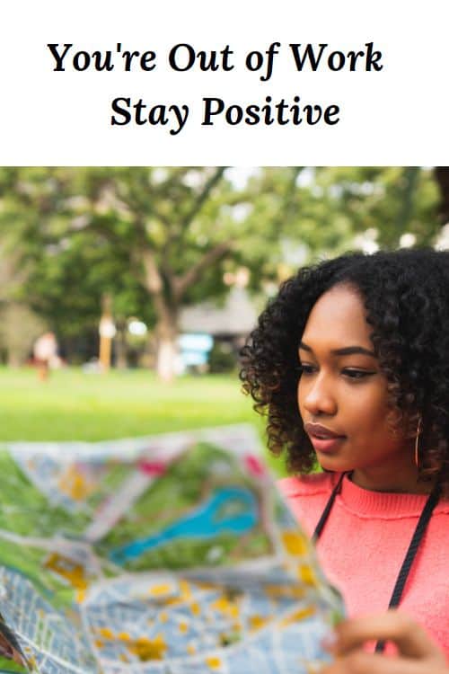 African American woman looking at a map and the words "Youre Out of Work Stay Positive"