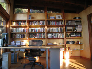 picture of desk and chair in front of a book case