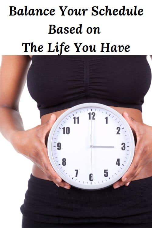 African American woman holding a clock in front of her waist and the words "Balance Your Schedule Based on the Life You Have"