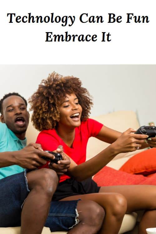 African American couple having fun playing video games and the words "Technology Can Be Fun - Embrace It"