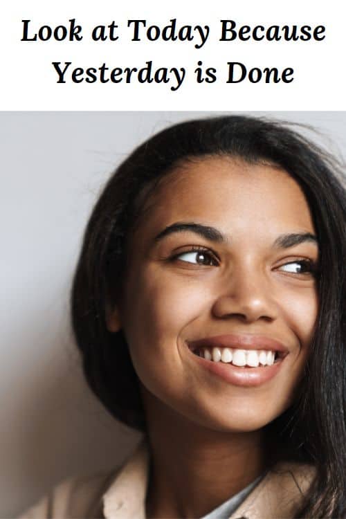 Smiling African American woman looking to the side and the words "Look at Today Because Yesterday is Done"