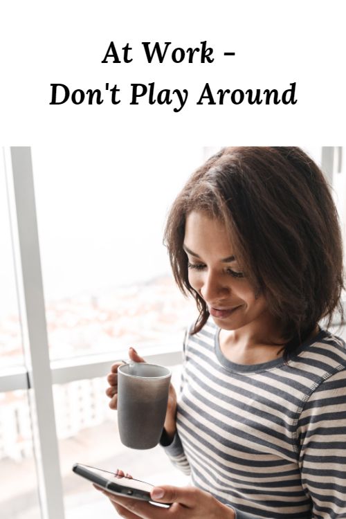African American woman with a cup of coffee and cell phone and the words "At Work - Don't Play Around"