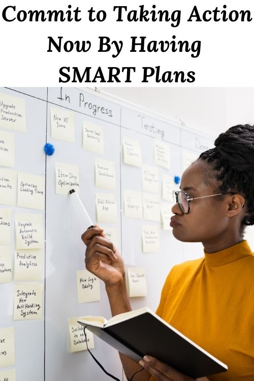 African American woman at a whiteboard with the words Commit to Taking Action Now By Having SMART Plans